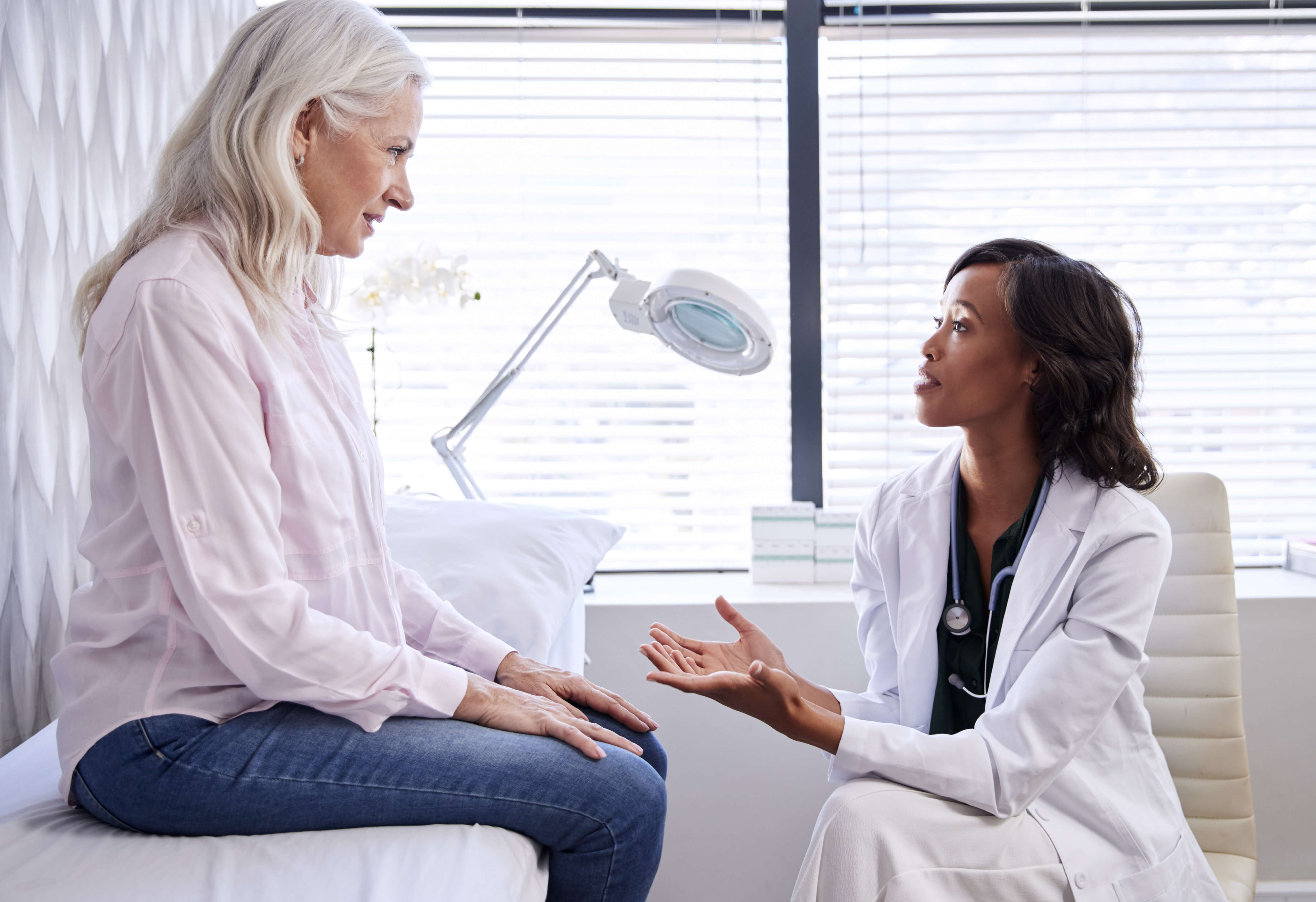 Older patience consulting with doctor