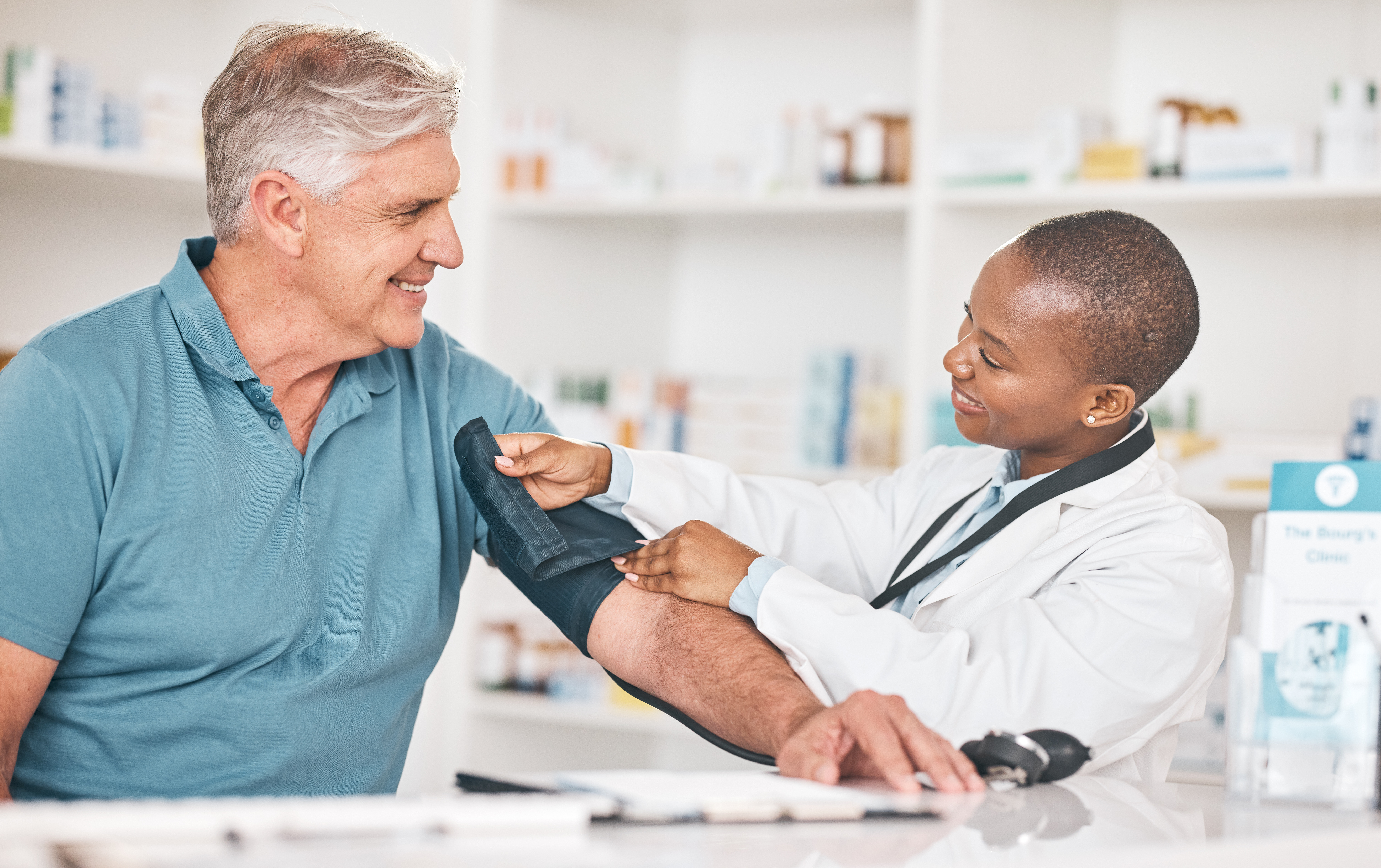 Woman doctor taking mans blood pressure 
