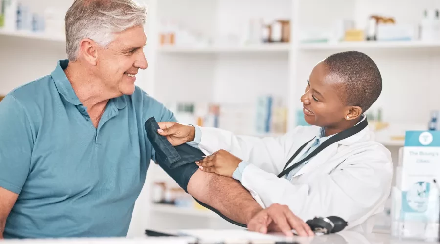 Woman doctor taking mans blood pressure