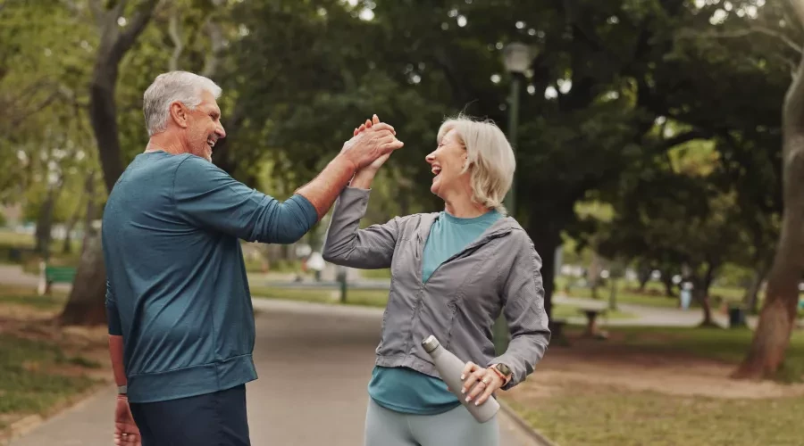 A middle aged man and woman high fiving