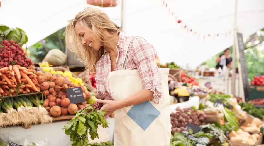 Woman smiling and shopping at Farmers Market