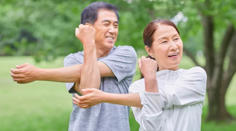 Couple outside doing Tai-chi