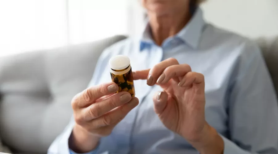 Woman looking at pill bottle