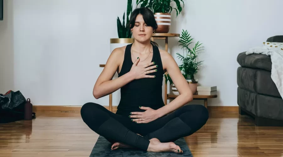 Woman on Yoga Mat doing breathing exercise