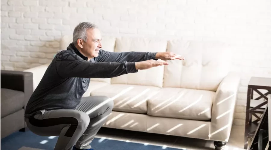 man stretching in living room