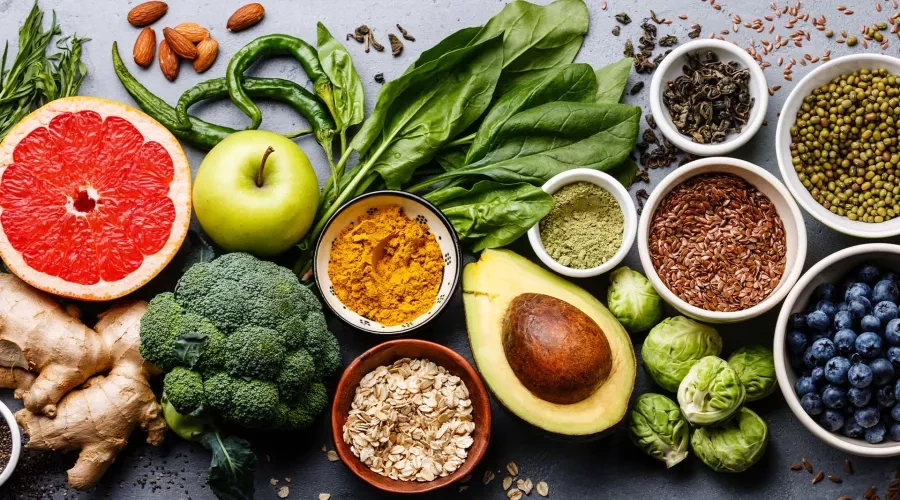 Colorful mix of nuts, fresh fruit, oats and spices layed out on a table