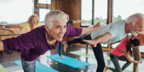 Couple doing yoga exercises in studio 