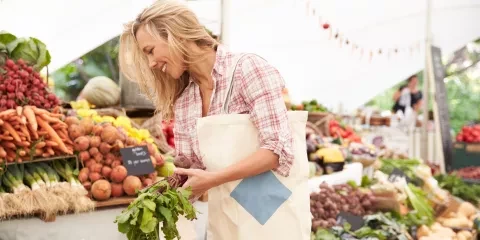 Woman smiling and shopping at Farmers Market