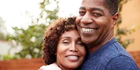 A couple hugging and smiling 