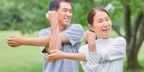 Couple outside doing Tai-chi