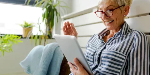 Older woman reading tablet 
