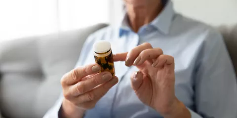 Woman looking at pill bottle