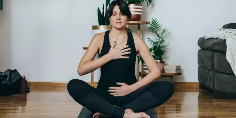 Woman on Yoga Mat doing breathing exercise