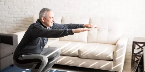 man stretching in living room