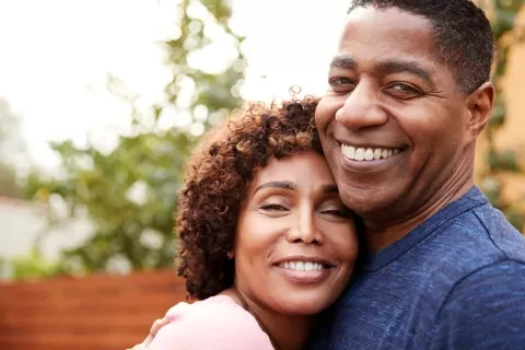 A couple hugging and smiling 