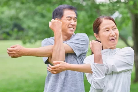 Couple outside doing Tai-chi